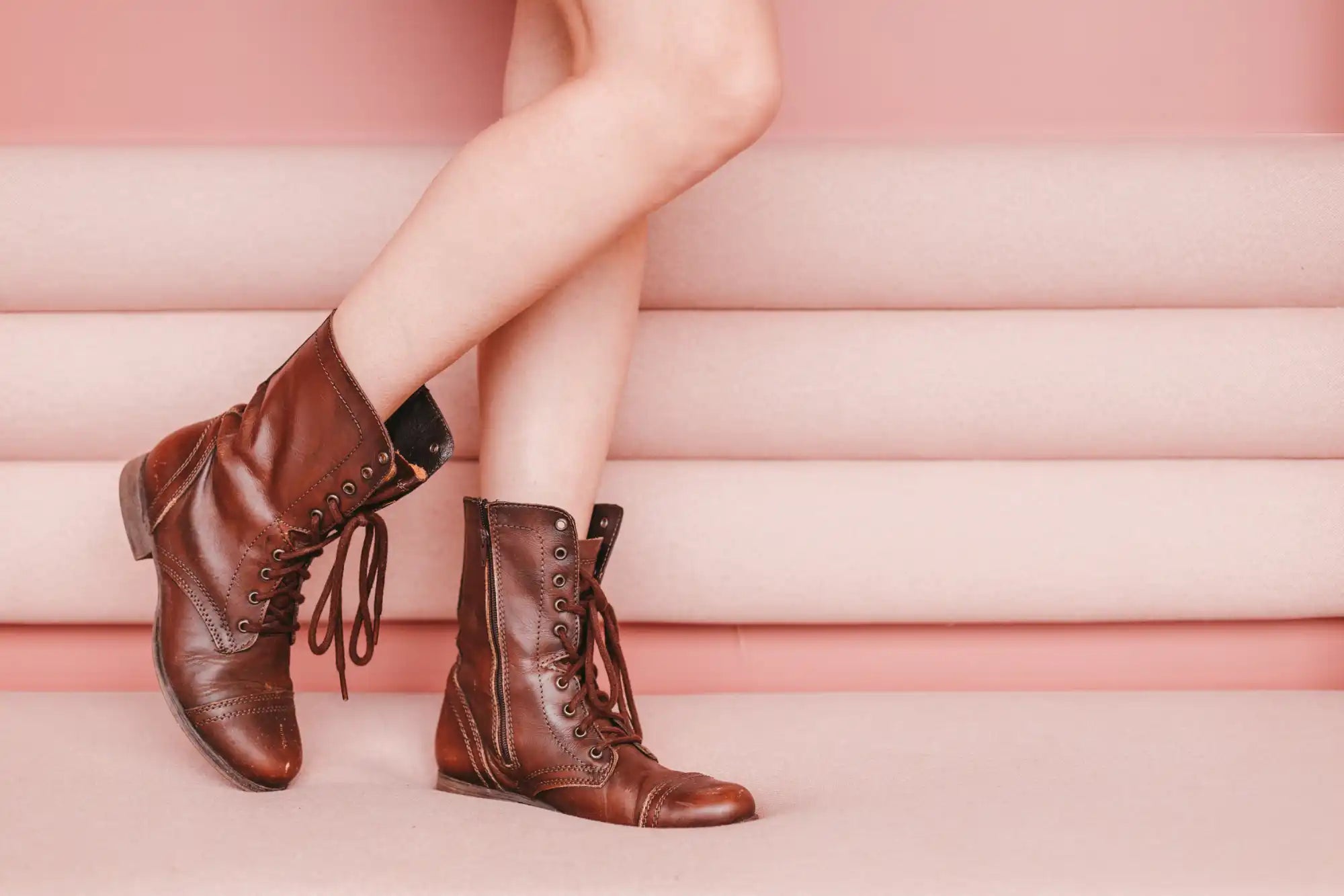 Brown leather lace-up combat boots with a vintage style.