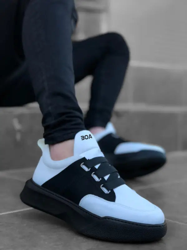 Black and white athletic sneaker with a chunky sole and contrasting panels.