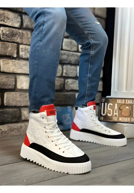 High-top sneakers featuring white, black and red color blocks with a chunky platform sole.