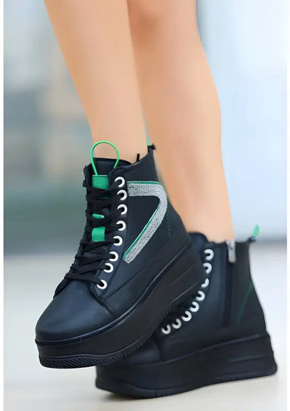 Black high-top sneakers with neon green accents and white laces.