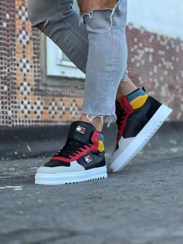 Colorful high-top sneakers with red, yellow, and black details on a white sole.