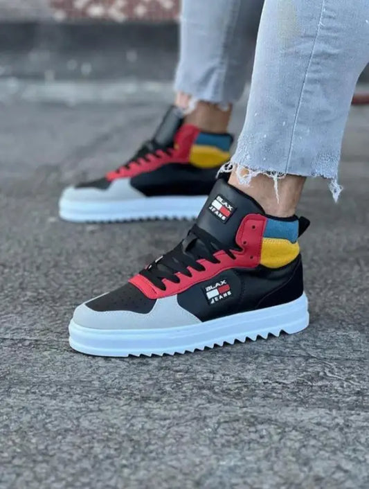 Colorful high-top sneakers with black, red, and yellow panels on a white platform sole.