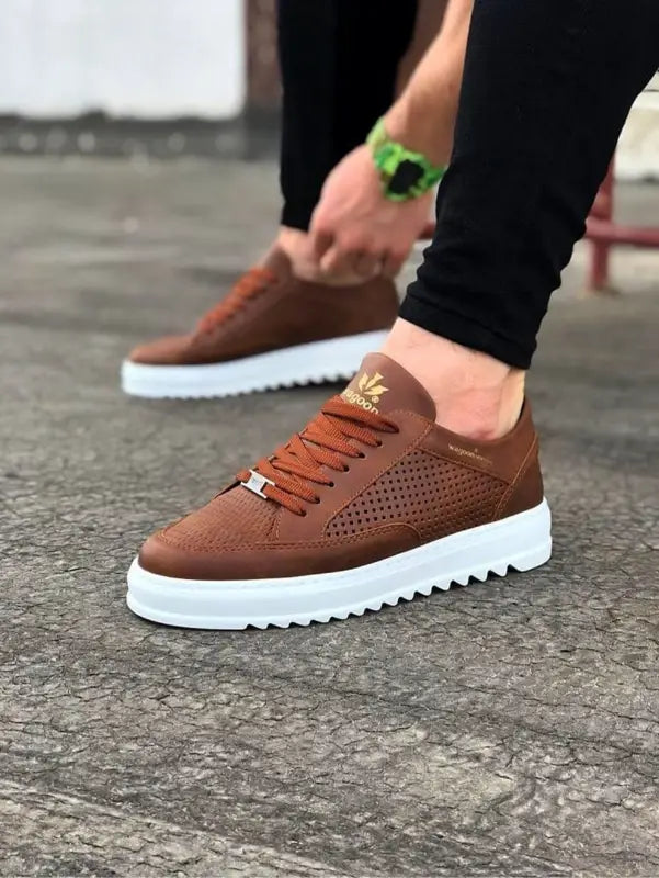 Brown suede sneaker with perforated details and a white platform sole.