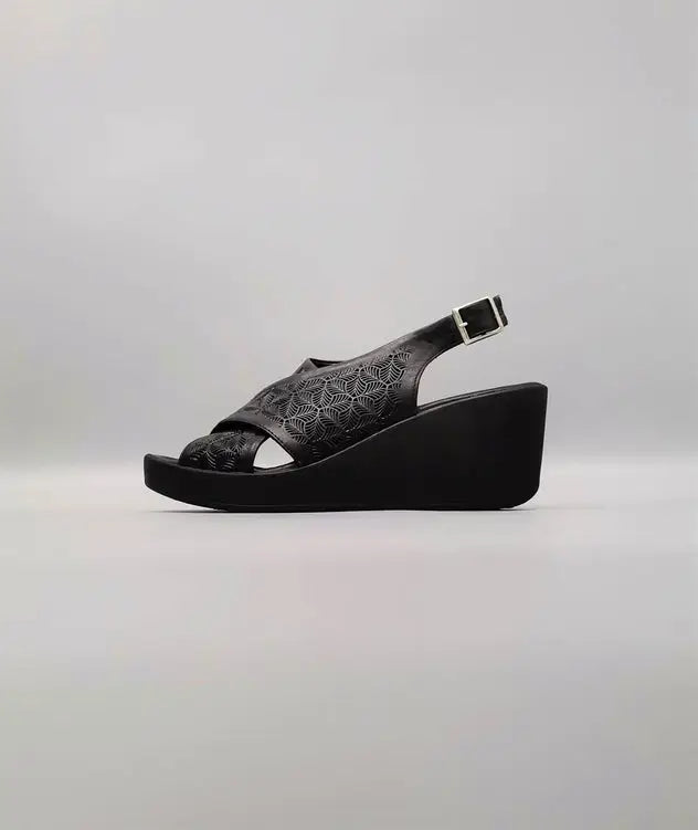 Black glittery wedge sandal with crossed straps.