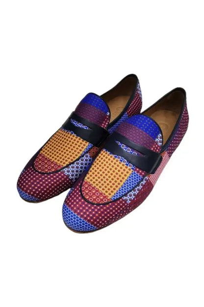 Colorful patterned loafers featuring blue, red, and yellow woven textures with a black strap across the top.