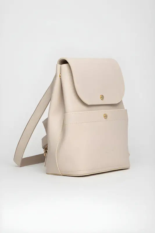 Cream-colored leather backpack with gold hardware and a flap closure.