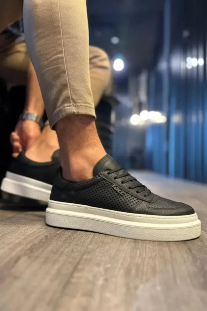 Black perforated leather sneaker with a thick white platform sole.