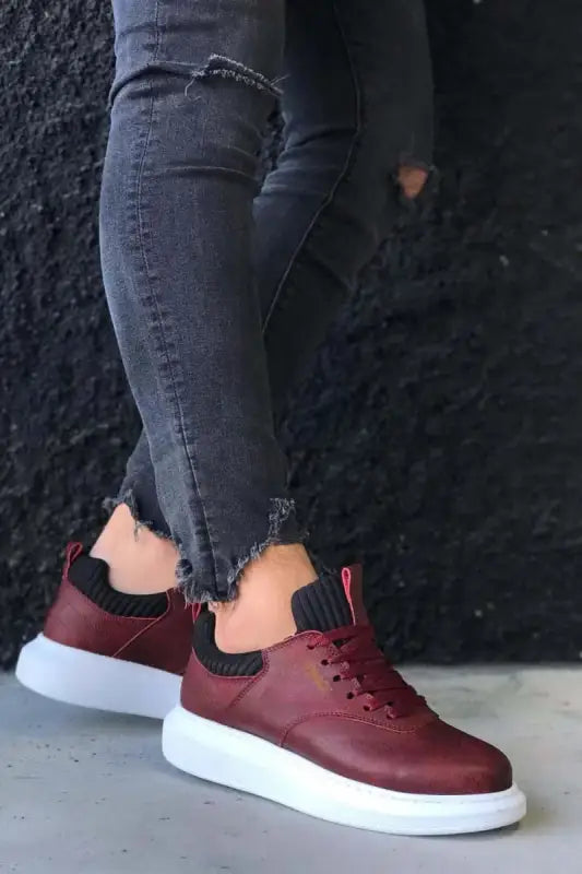 Burgundy leather sneakers with white platform soles and black laces.