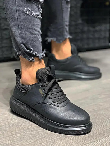 Black leather sneaker with a thick sole and textured upper design.