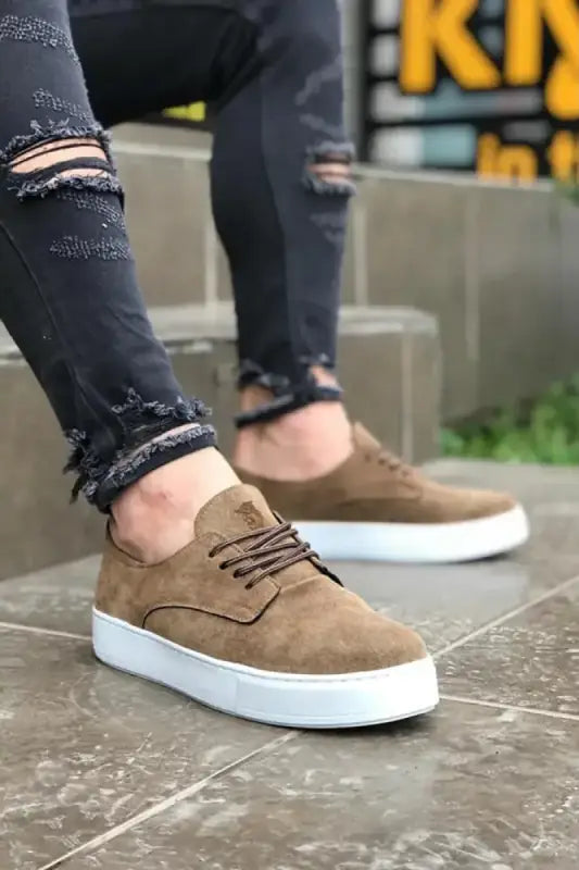 Brown suede sneaker with white sole and laces.