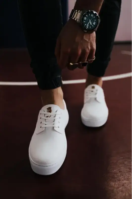 White canvas lace-up sneakers with a platform sole.