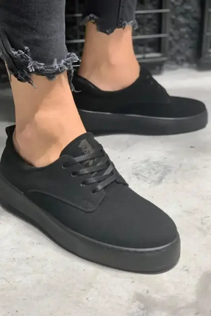 All-black canvas sneakers with a thick platform sole and black laces.