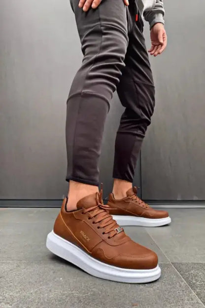 Brown leather sneakers with white platform soles and matching laces.