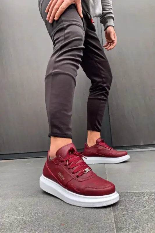 Burgundy leather sneakers with thick white soles and matching laces.