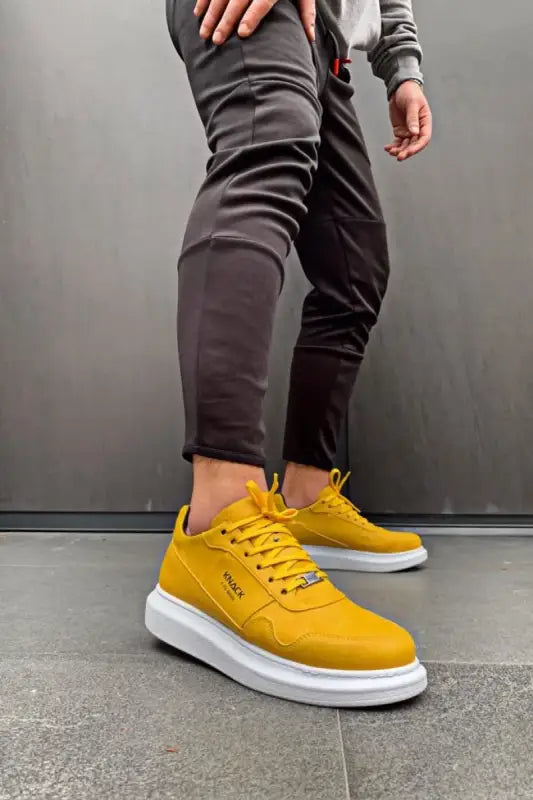 Bright yellow sneakers with white soles and matching laces.