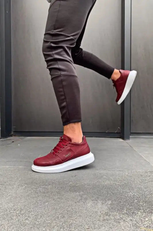 Burgundy leather sneakers with thick white soles.