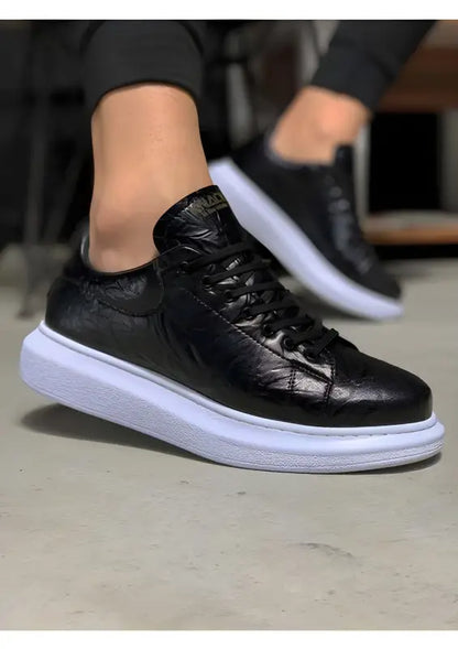 Black leather sneaker with a thick white sole.