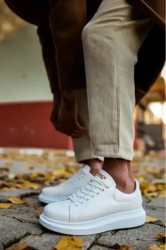 White leather sneaker with thick platform sole and laces.