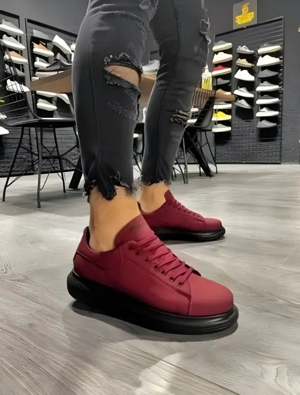 Burgundy sneakers with black platform soles and matching laces.