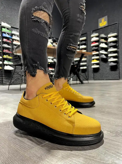 Bright yellow sneakers with black platform soles and yellow laces.