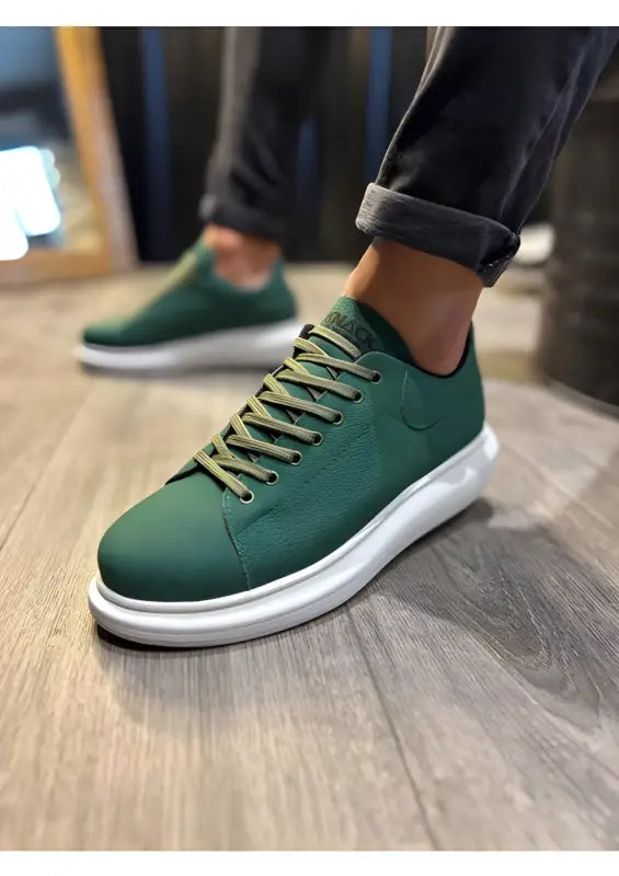 Forest green sneaker with white platform sole and matching laces.