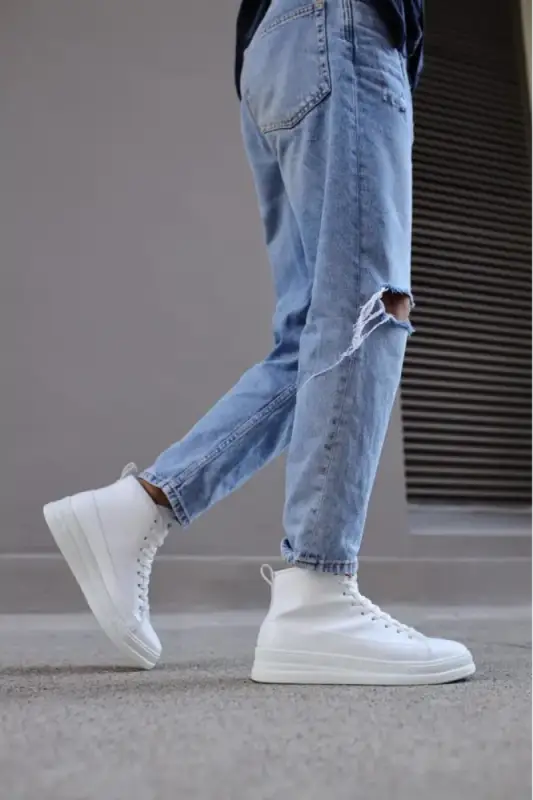 White high-top sneakers paired with ripped light-wash jeans.