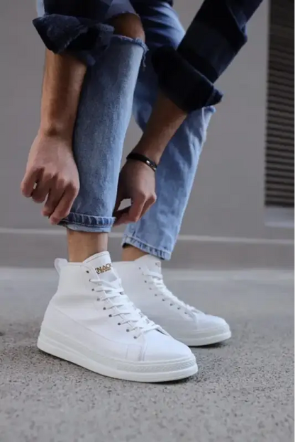 White high-top sneakers with laces paired with rolled-up blue jeans.