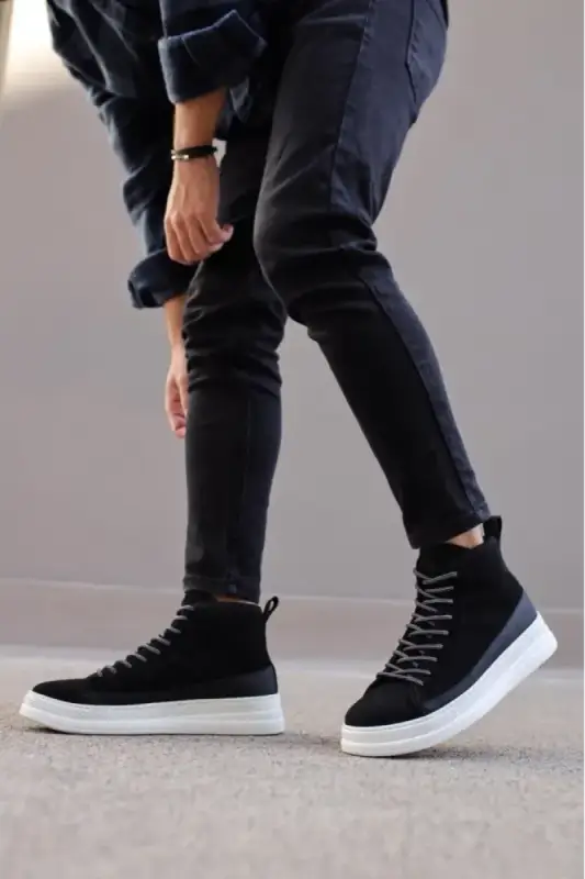 Black high-top sneakers with white soles and dark laces.