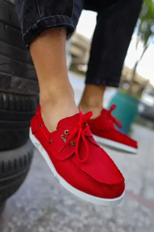 Bright red canvas sneakers with white soles and red laces.