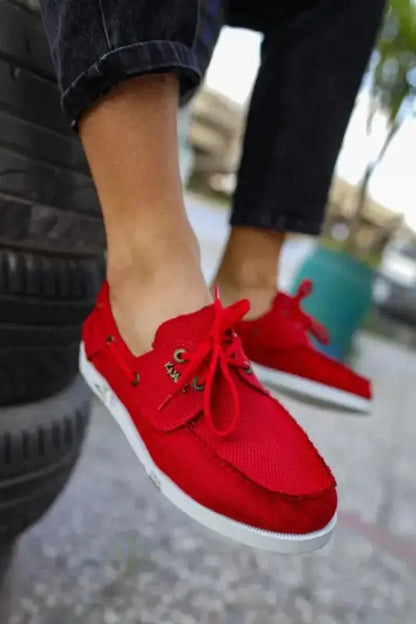 Bright red canvas sneakers with white soles and red laces.