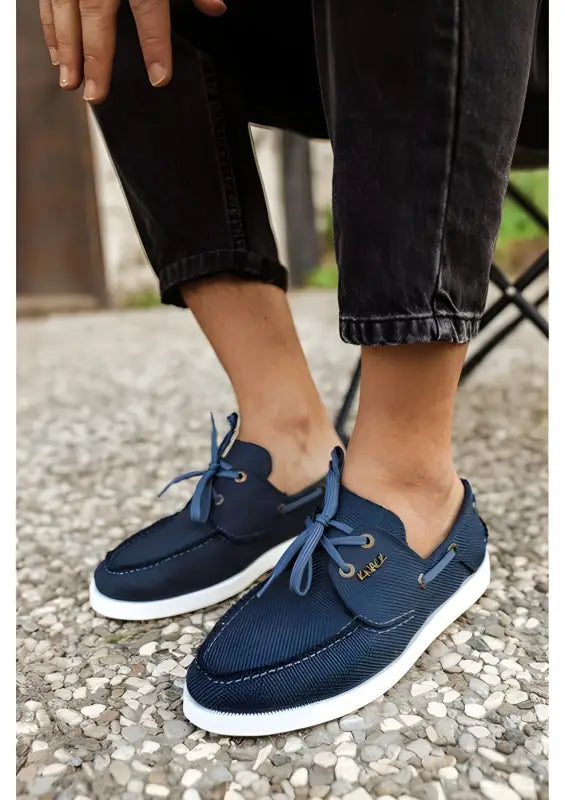 Navy blue boat shoes with mesh fabric and white soles.