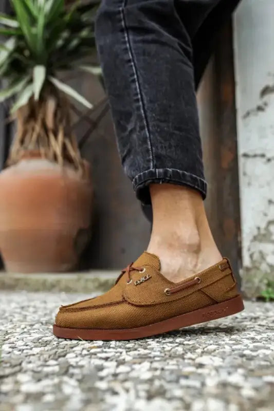 Brown leather boat shoe with classic moccasin-style stitching.