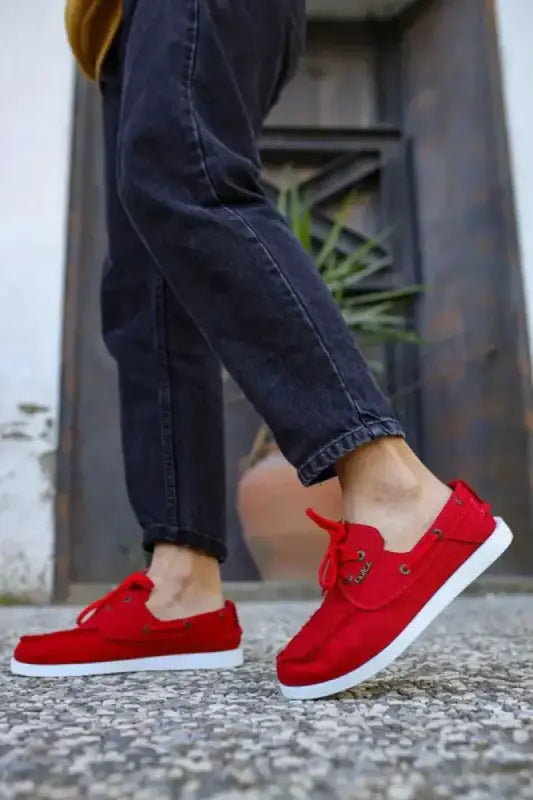 Bright red canvas lace-up sneakers with white soles.