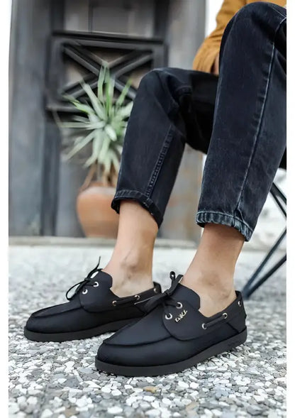 Black leather boat shoes with laces and a moccasin-style design.