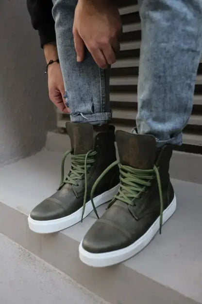 High-top olive green sneakers with white soles and contrasting green laces.