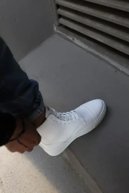 White high-top sneaker with laces.