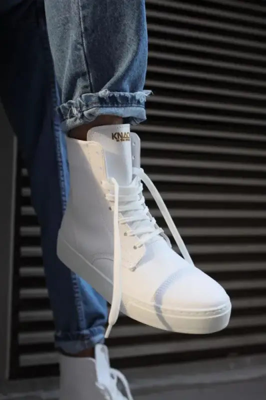 White high-top canvas sneaker with laces.