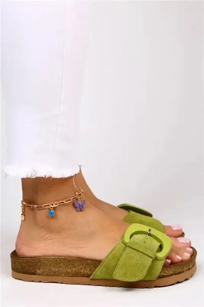 Lime green suede sandal with a cork sole and buckle strap.