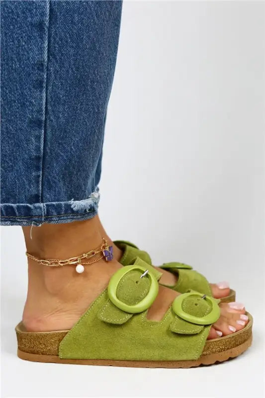 Lime green suede sandal with buckles and a cork footbed.