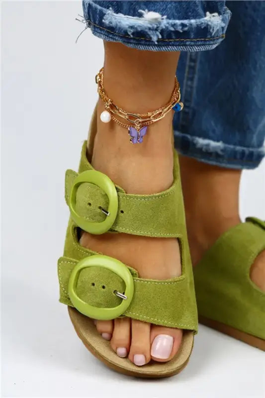 Lime green suede sandal with two oversized buckle straps.