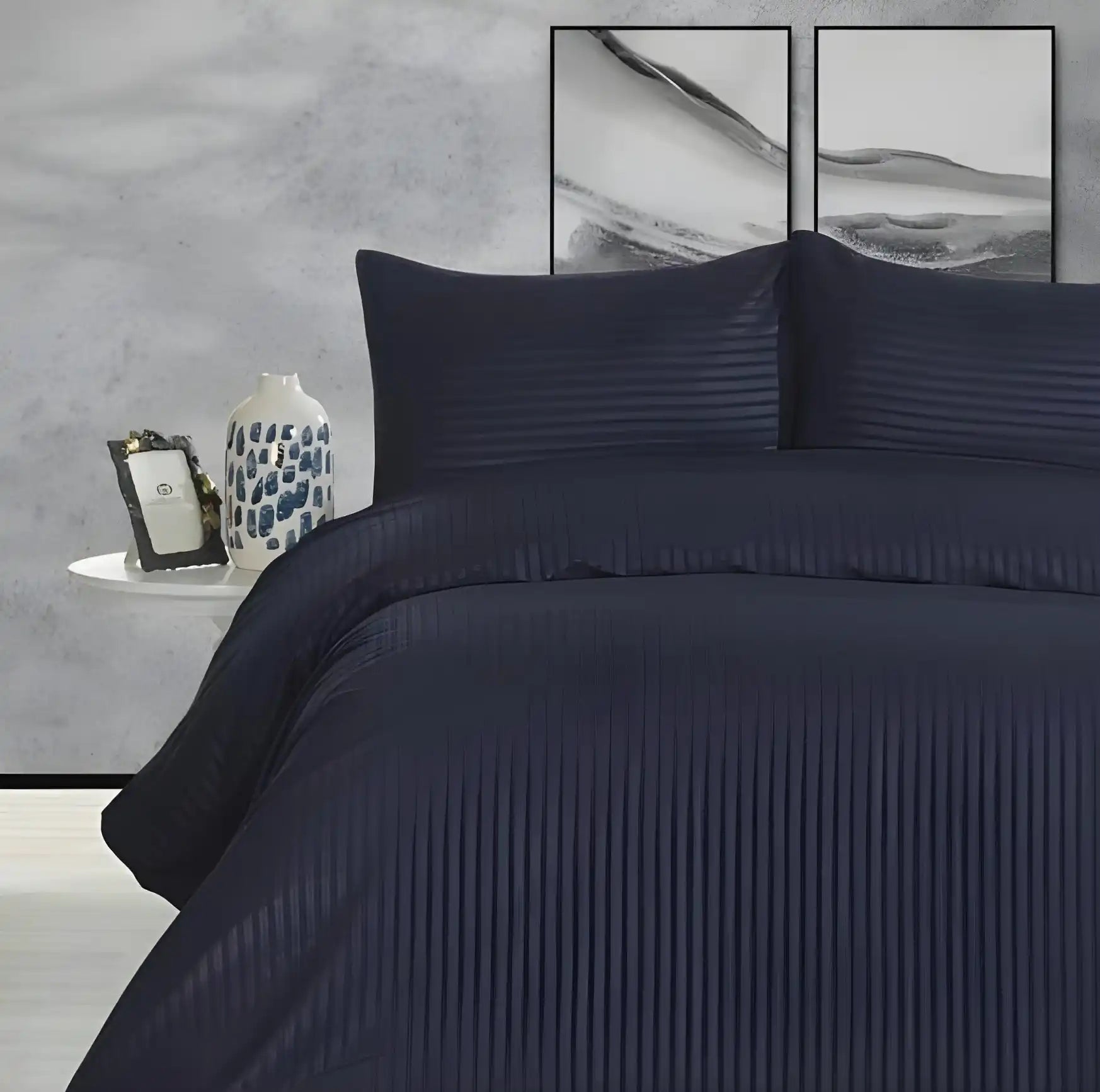 Navy blue striped duvet cover with matching pillowcases on a bed.