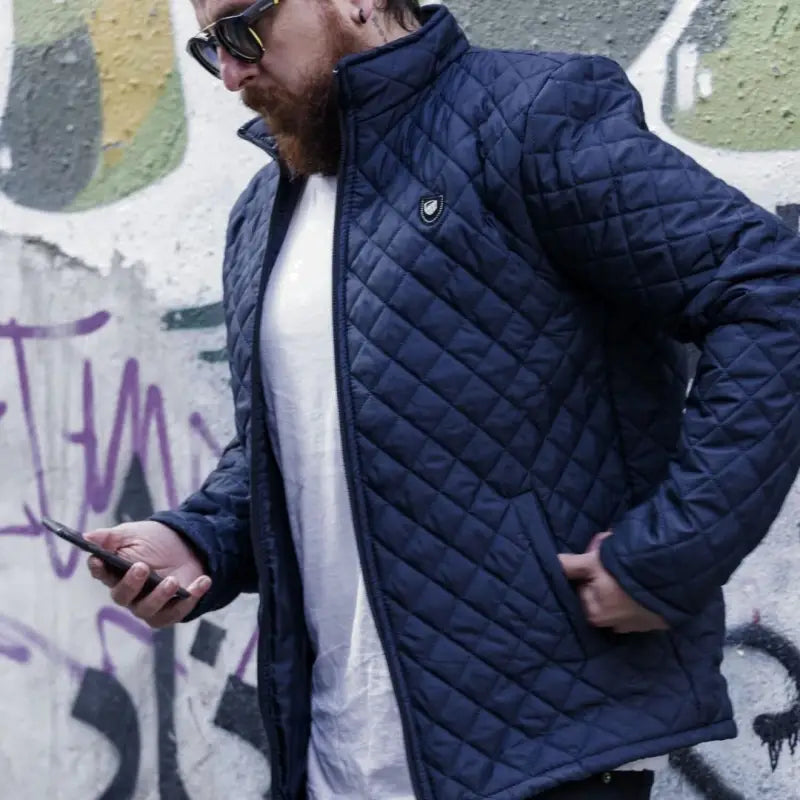 Navy blue quilted jacket with diamond pattern stitching.