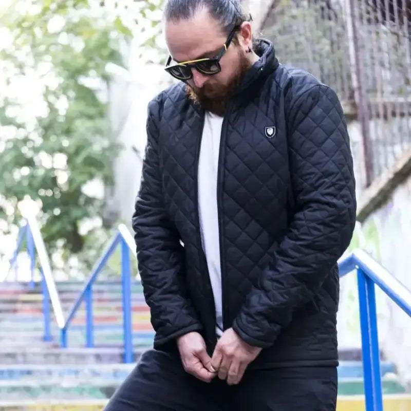 Black quilted winter jacket with a white undershirt.