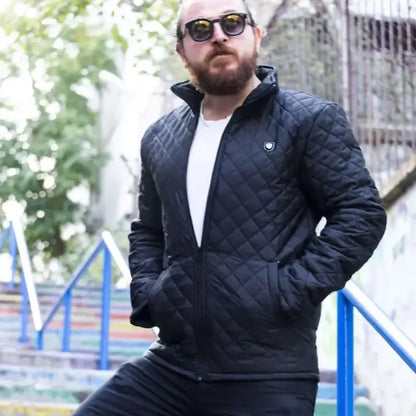 Quilted black zip-up jacket with a white t-shirt underneath.