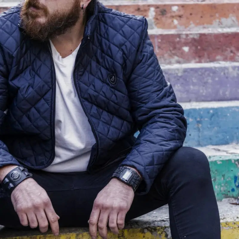 Navy blue quilted jacket with a diamond pattern.