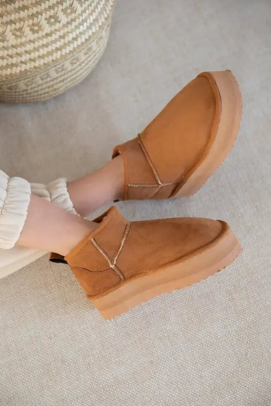 Tan leather slip-on shoes with elastic side panels and a chunky sole.