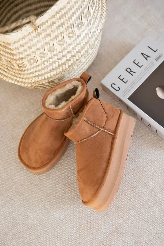 Tan suede ankle boots with fuzzy interior lining.