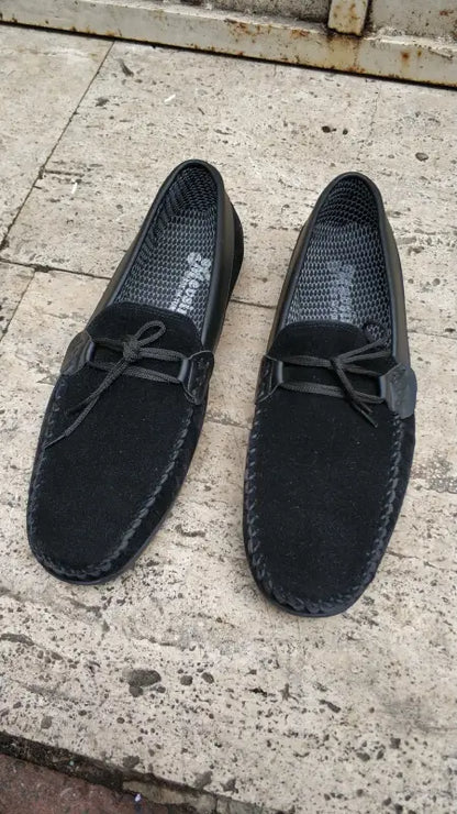 Black suede driving loafers with bow detail.