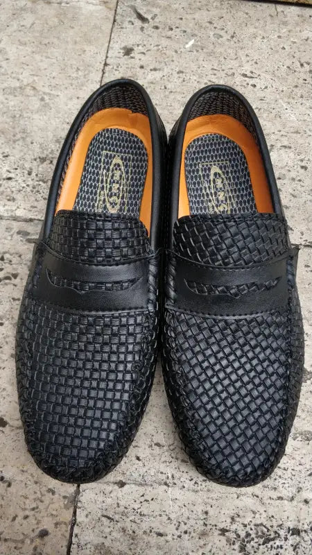 Black woven leather loafers with penny keeper straps.