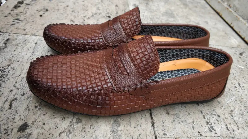 Brown woven leather loafers with a moccasin-style design.